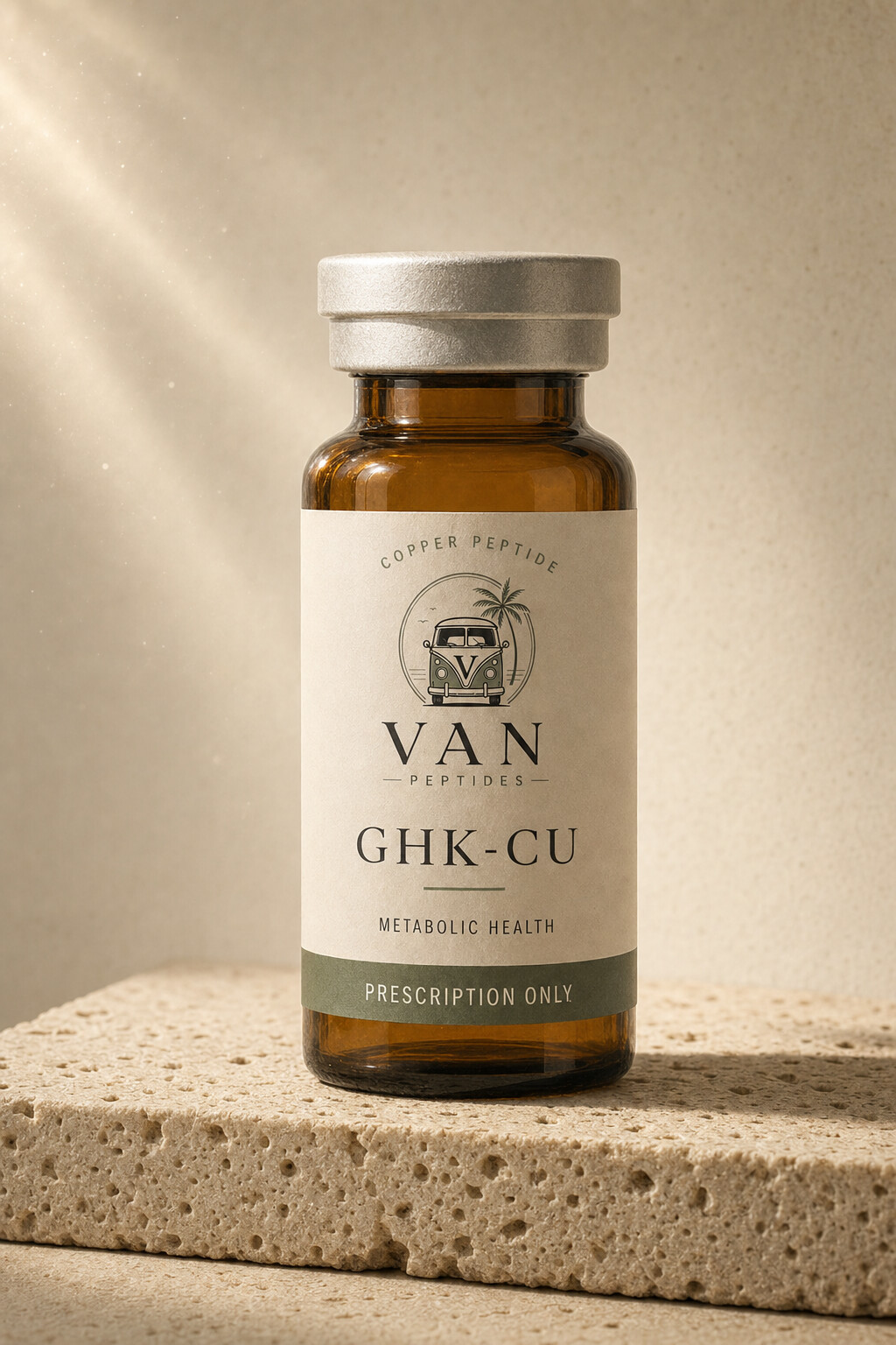 Amber apothecary vial with a cream label reading GHK-Cu, Prescription Only, on a travertine surface