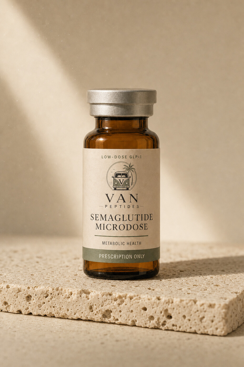 Amber apothecary vial with a cream label reading Semaglutide Microdose, Prescription Only, on a travertine surface