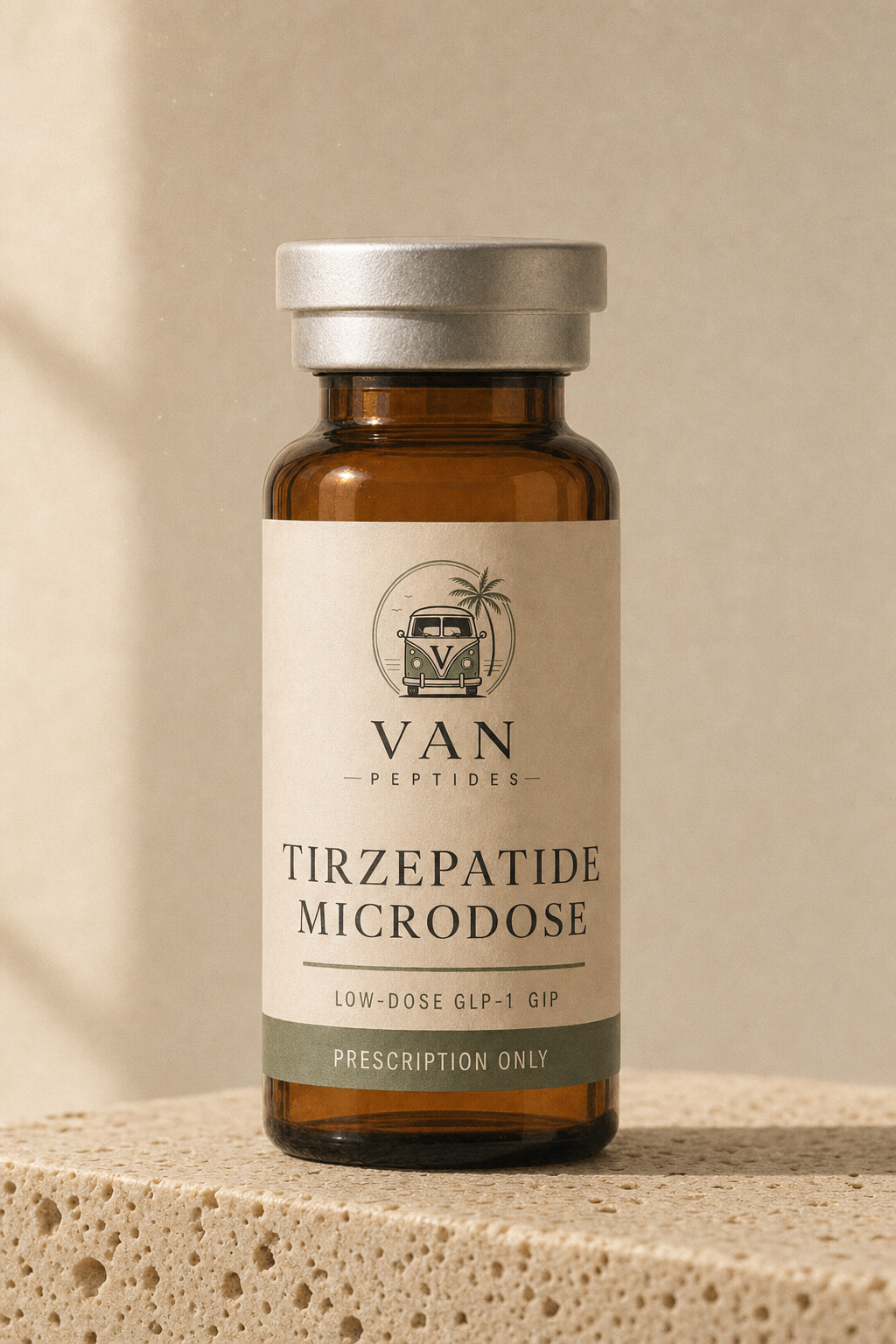 Amber apothecary vial with a cream label reading Tirzepatide Microdose, Prescription Only, on a travertine surface